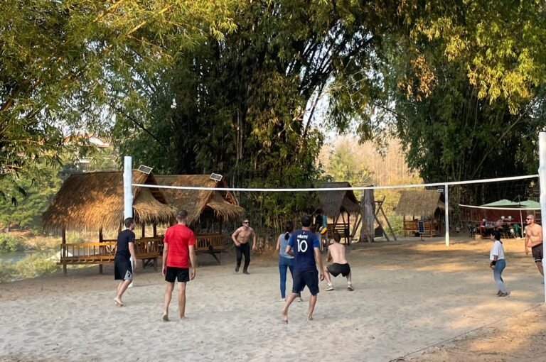 Friends gathering to play volleyball in Luang Prabang